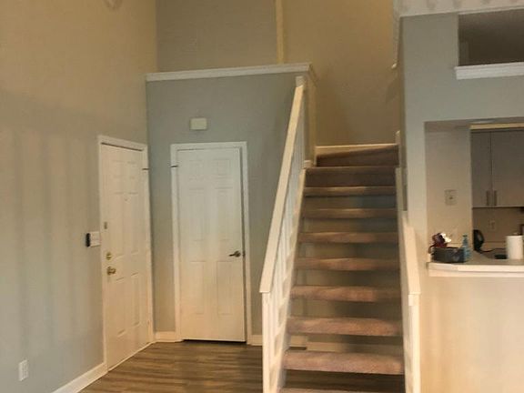 Front door entry, closet and stairs to upstairs bedroom and full bathroom.