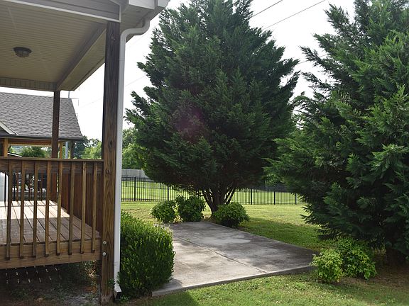 Covered back porch and patio in completely fenced back yard.