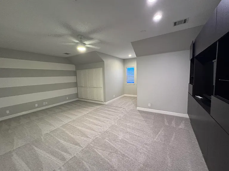 Large bonus room with built in entertainment center can be used as a media room or 5th bedroom