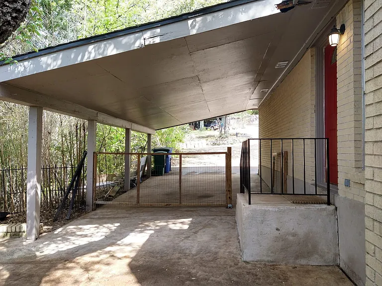 View of attached covered private carport from the side yard.