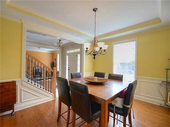 Open & bright dining room features a trey ceiling,