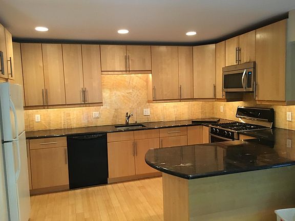 Kitchen with Large Island and Onyx Backsplash
