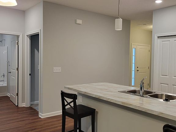 Entry hallway with second bathroom, entry to front bedroom