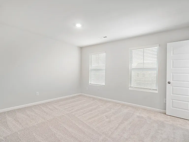 Upstairs bedroom 4 with ceiling fan.