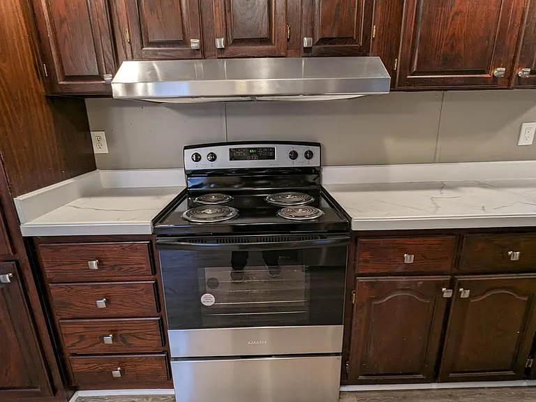 close up of stove with large pantry to left