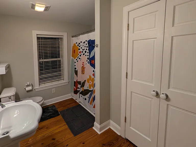 The bathroom has a large linen closet.