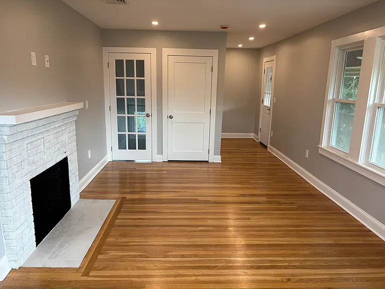 Living Room - Refinished hardwood floors, new insulation, new doors, new windows, new sheetrock, and new electrical.