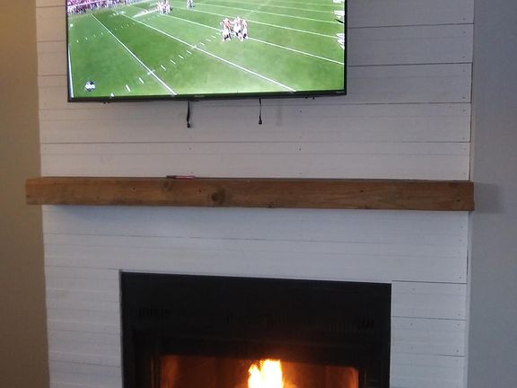 Flat screen TV in Livin Room over fire place.