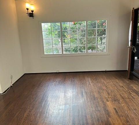 Opposite end of living room, has large picture window facing nature.