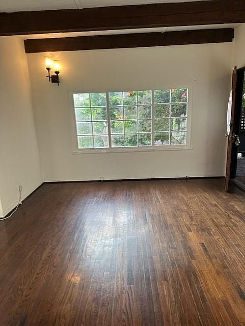 Opposite end of living room, has large picture window facing nature.