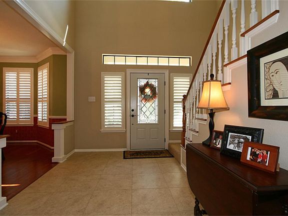 This Wonderful & Open Entry Leads Into The Formal Dining Area & Boasts High Ceilings, Beautiful Arch