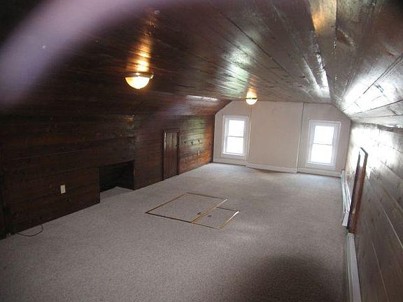 Unit 5 what it looks like without furniture. Fire escape trap door in floor. Large closet behind camera.