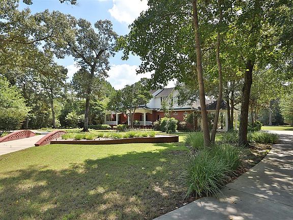 Nestled in the trees! Circular driveway as well as separate driveway to garage! Tons of parking space for friends and family!