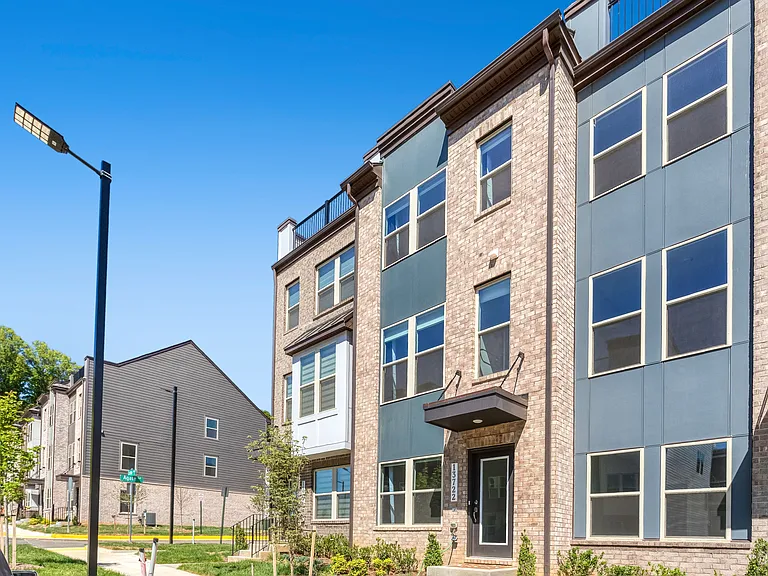 Stunning front exterior showcasing modern design, great curb appeal, and a prime location in the sought-after Quartz District community.