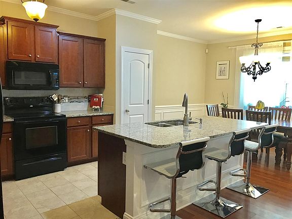 Kitchen overlooks Dining and Living Areas.