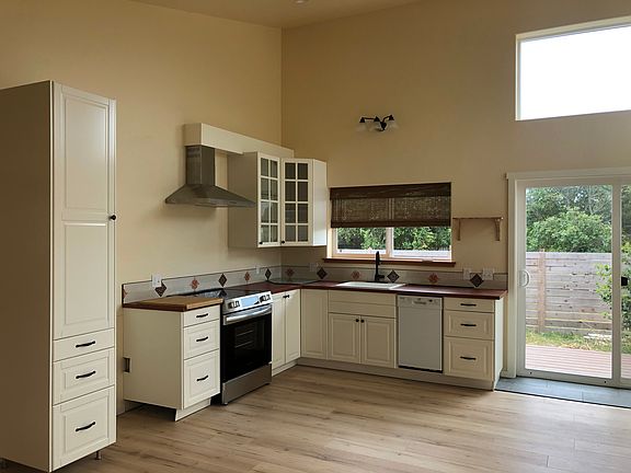 The kitchen with talavera tile and an induction stove. The fridge is now to the right of the pantry.