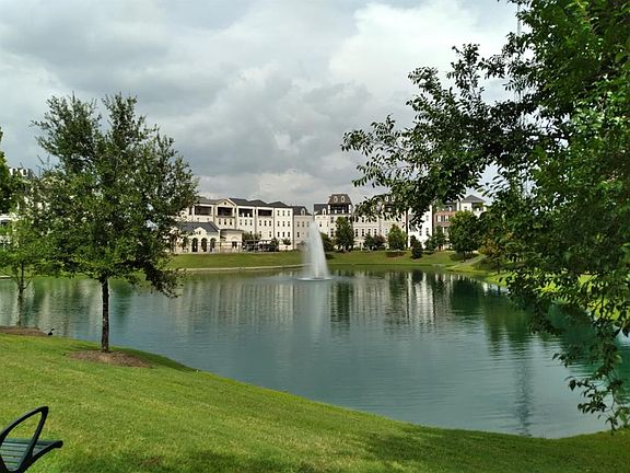 Once inside the manned gated is your little oasis inside the loop! Tranquil pond with fountain. The pool, cabana and homes are in the background.