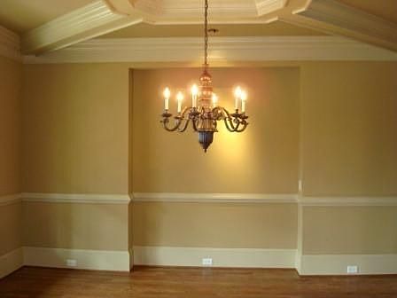 Equisite mouldings and lighting fixtures in formal dining room!
