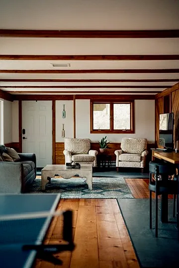Lower level showing reading area, 55" TV, Ping-pong table and couch