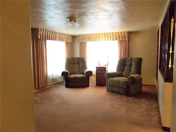 Living room - open to kitchen, large widows let in plenty of natural light.