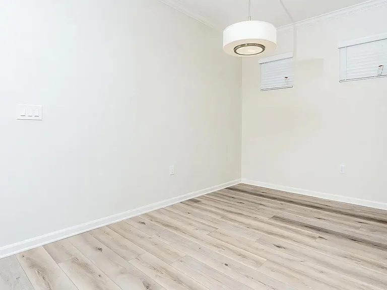 Open Living Area with Natural Light and Light Wood Flooring
