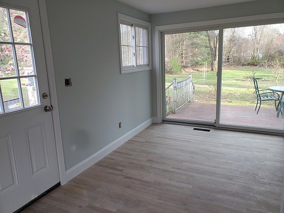 Side door entrance from driveway and eat-in kitchen area by slider doors