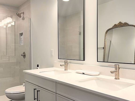 Double vanity sinks with glass walk-in shower