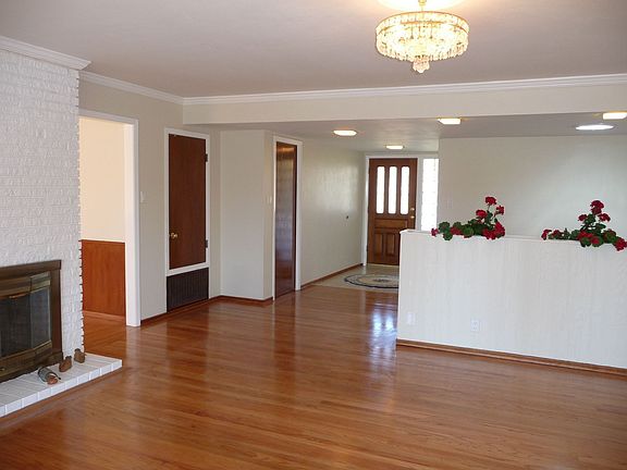 Entrance foyer into living room w/ fireplace