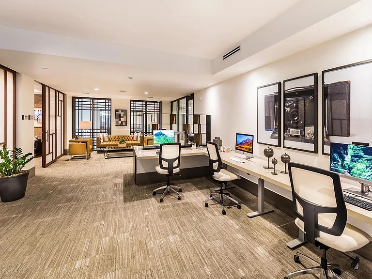 Business center with work stations and a coworking lounge for focused productivity.