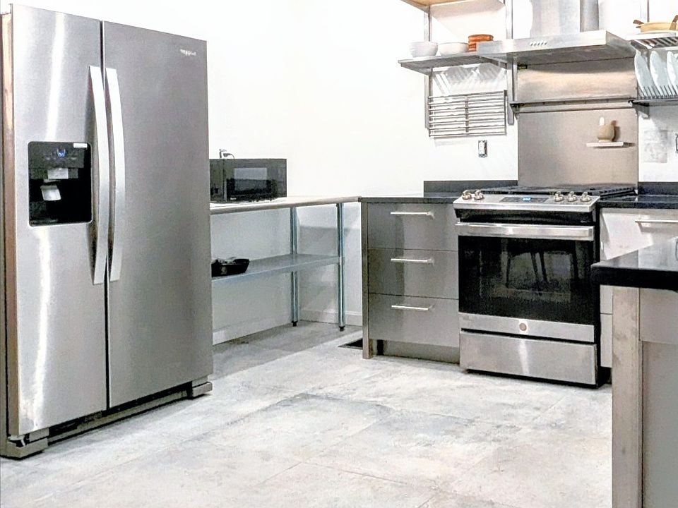 Newly designed state of art kitchen w/ stainless cabinets & appliances. Dishwasher, Garbage Disposal & Laundry all included within Kitchen.
