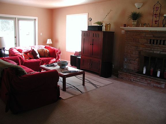 Living room with fireplace and french doors leading to backyard