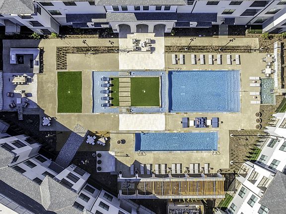 Grand pool courtyard with large resort-style swimming pool and plunge pool.