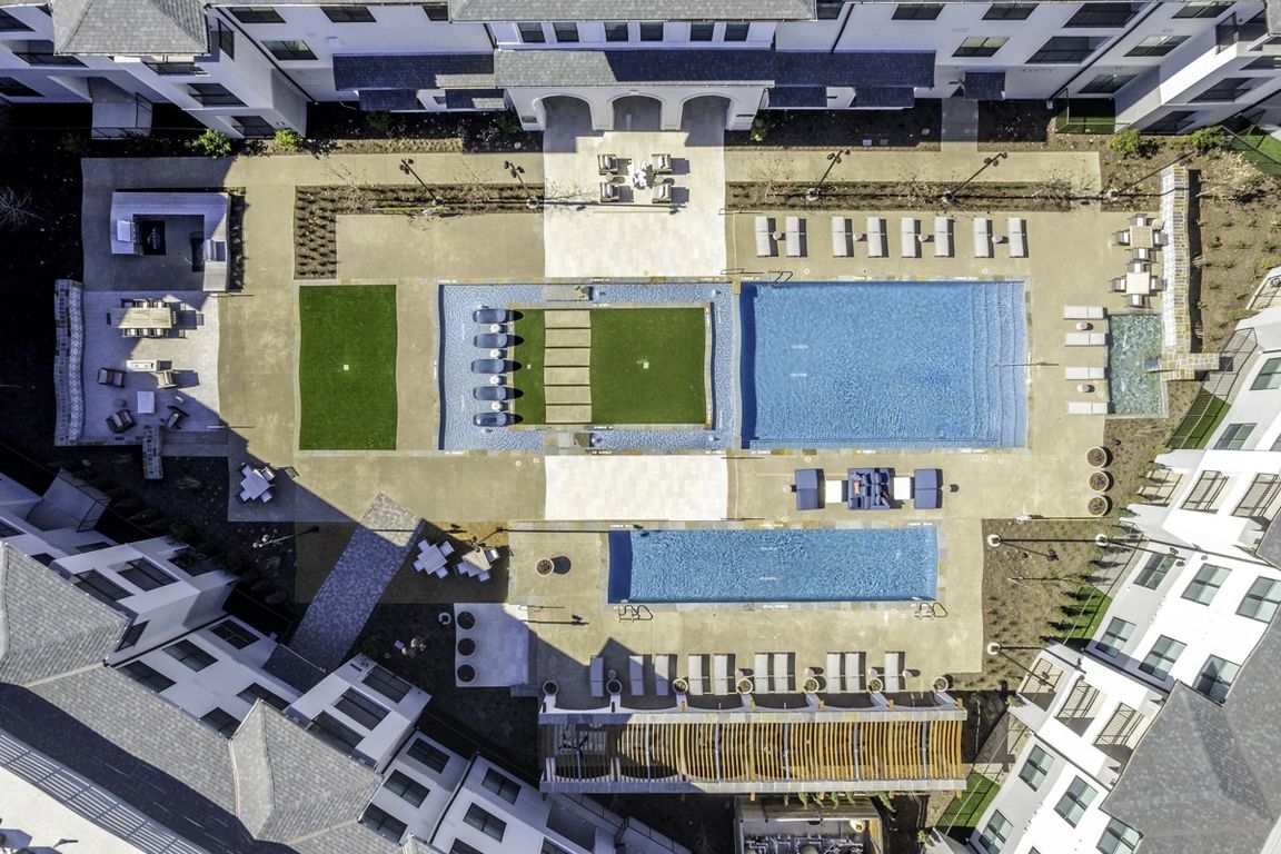 Grand pool courtyard with large resort-style swimming pool and plunge pool.