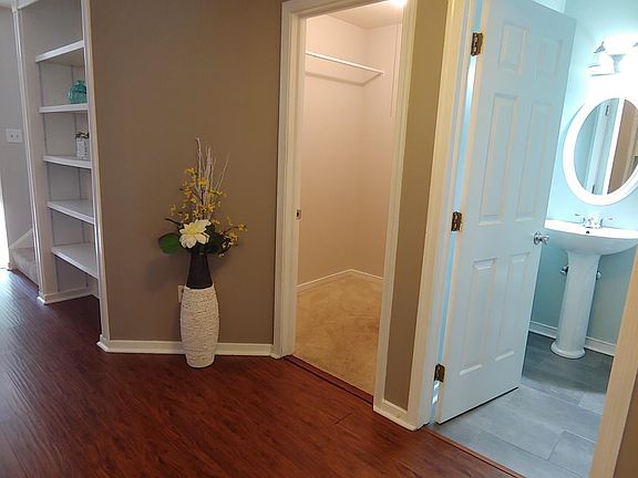 Entryway with half bath to the right and large closet and storage.