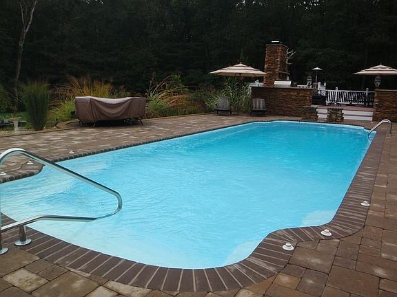 Inground pool surrounded by custom design pavers. 