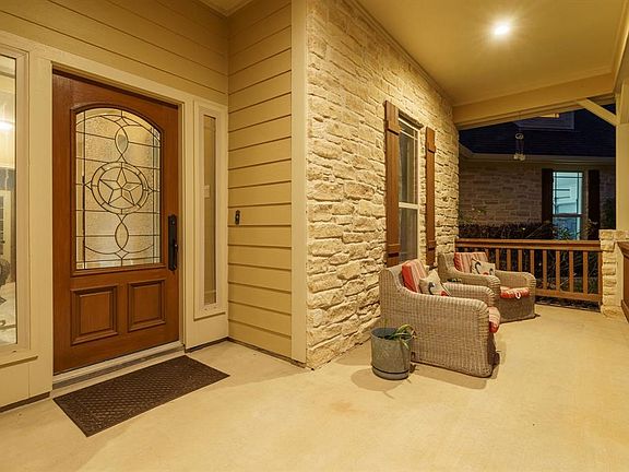 Spacious front porch for plenty of seating - gorgeous front door -
