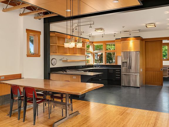 
                    A closer look and the dining and kitchen area. Behind that sliding door is the laundry room-with access to the side yard/dog run/garage & alley/exterior access to the upstairs ADU (photo later in this gallery).
                