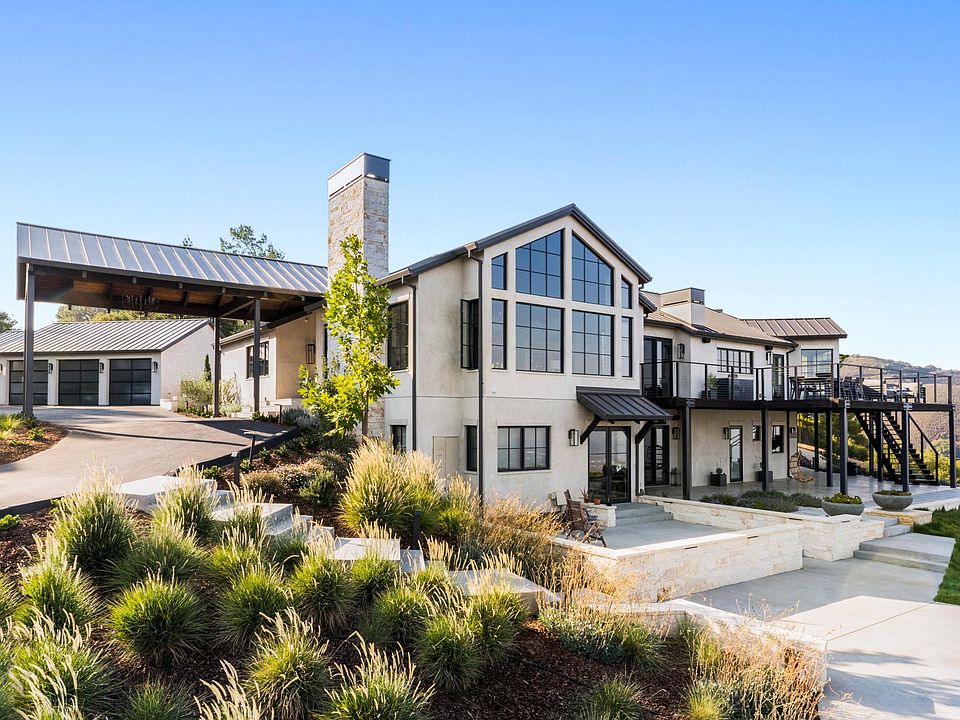 The front door to the in-law style apartment is on the lower level, and separate from the main entrance. One covered parking spot is provided (left side of garage).
