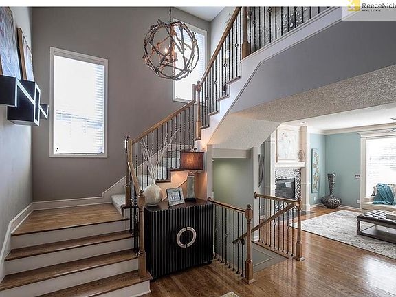 Wood stairs designer colors and lighting fixtures throughout