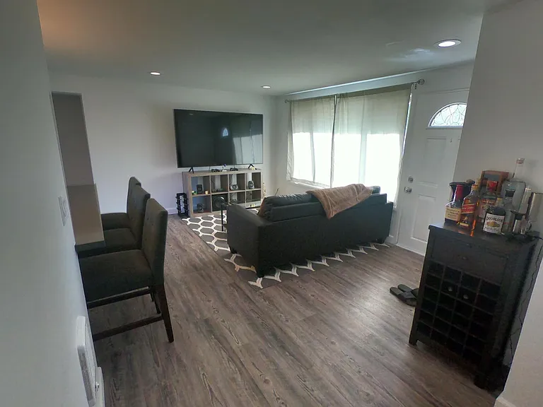 View of entry space and living room from hallway.
