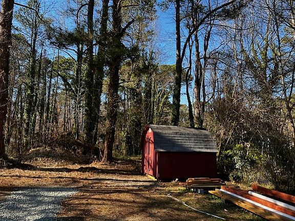 Storage shed in backyard for bikes, holiday storage, gardening supplies. New roof has been put on since this photo.
