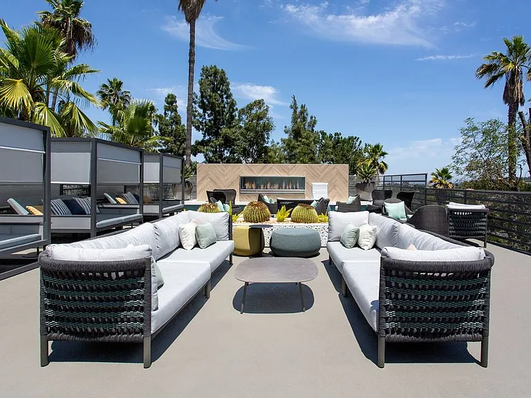 Outdoor lounge with cabanas and fireplace