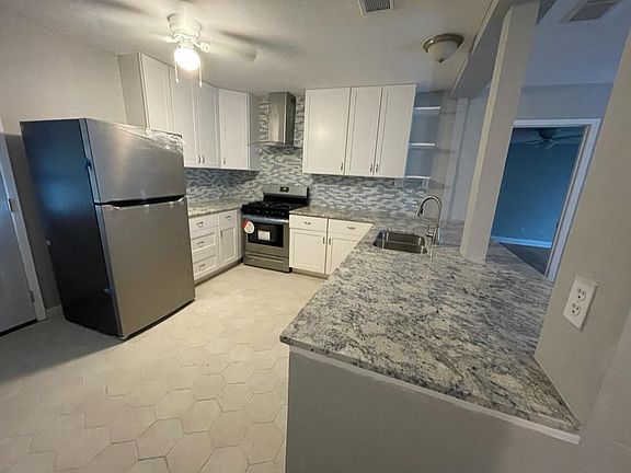 Remodeled kitchen - everything is new! Floors, granite counters, cabinets, and stainless steel appliances, including a dishwasher.