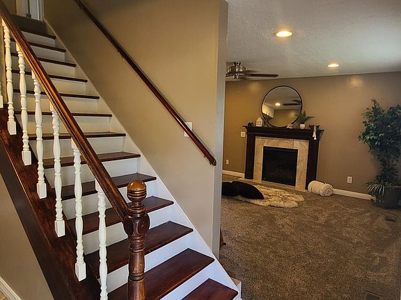 Front entrance view of stairs, living room & kitchen.