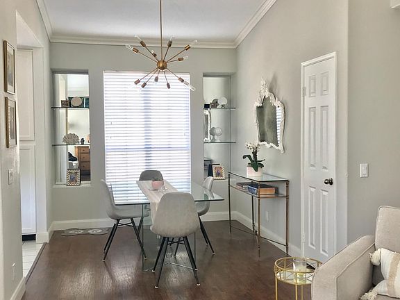 Dining room with custom mirror & glass shelves and new chandelier