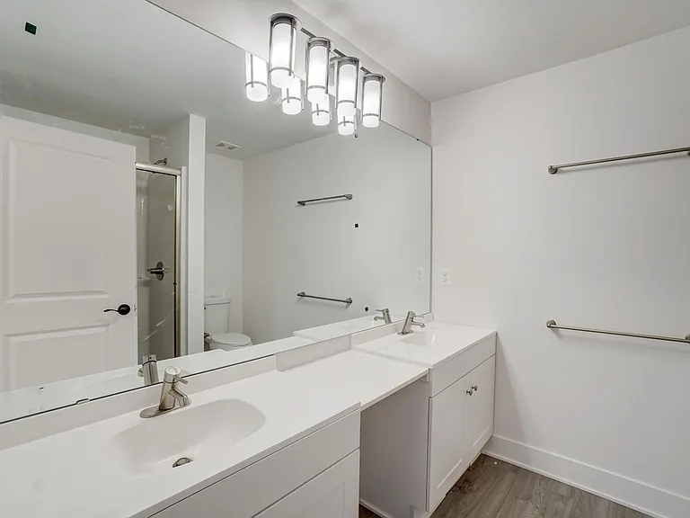primary suite private bath with dual vanities and lots of counter space