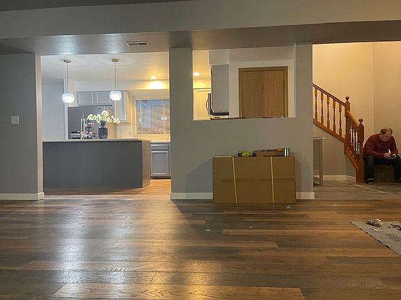 Living room looking into the kitchen and foyer.