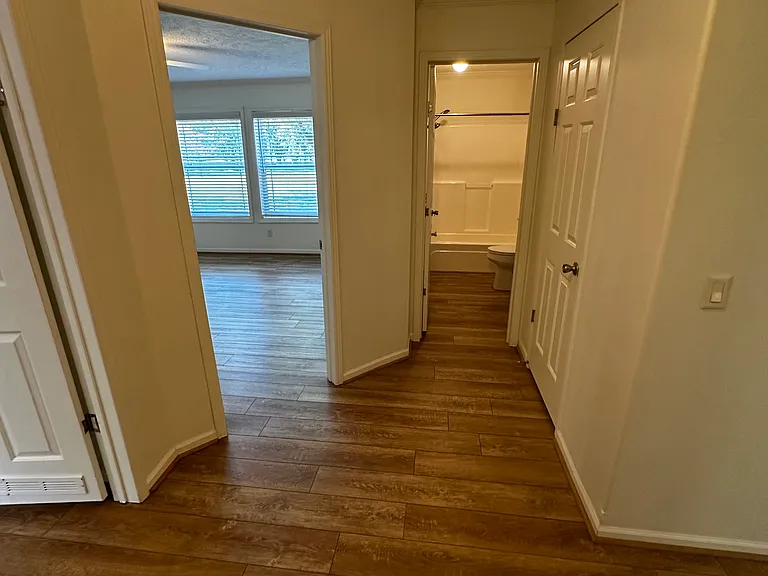 Exiting the laundry room. Looking at the guest bath and two bedrooms.