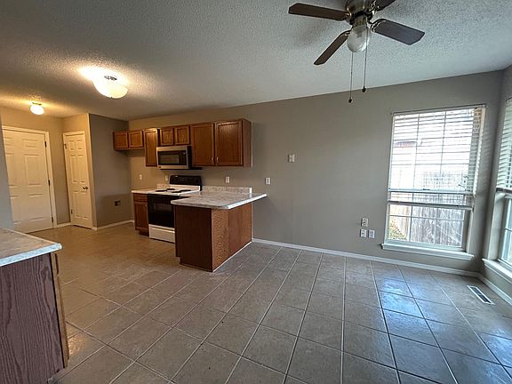 Another view of kitchen, including dining / area for table.