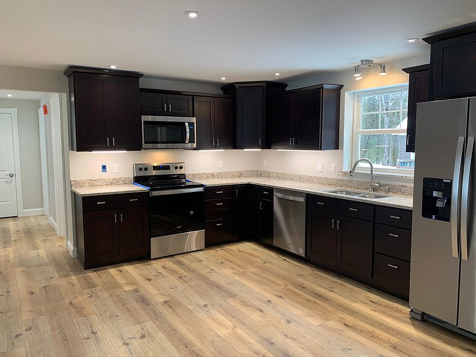 Kitchen features stainless steel appliances, granite counters, under cabinet lighting, with soft-close cabinets.